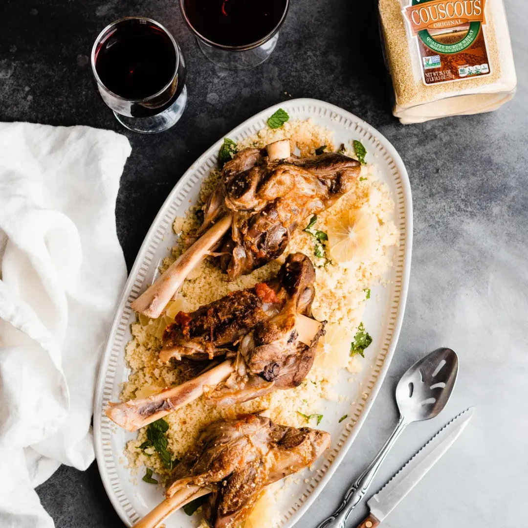 https://d3xhk4vytuuf2.cloudfront.net/Lamb-Shanks-with-Lemon-Couscous-Recipe.webp